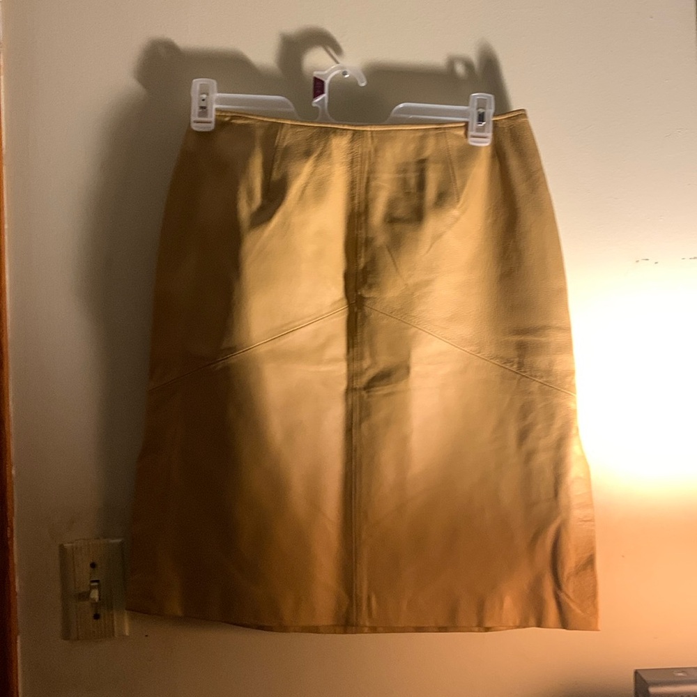 Tan leather skirt with lining zip split on right and left  pencil shape.